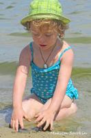 [River 2019] Curly little girl in a blue swimsuit