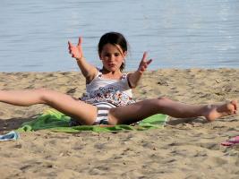 Young teen flexing on beach